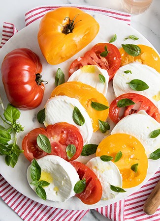 plate of mozzarella cheese and heirloom tomatoes